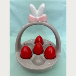 Κεραμική Πασχαλινή Αυγουλιέρα . Σε σχήμα καλαθιού σε γκρι χρώμα με λευκά πουά. Η λαβή καταλήγει σε χαριτωμένα αυτιά λαγού με έναν ροζ φιόγκο.